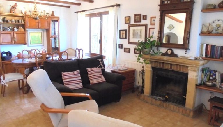 Living room with fireplace in a villa for sale in Jávea - Xabiga Inmobiliaria