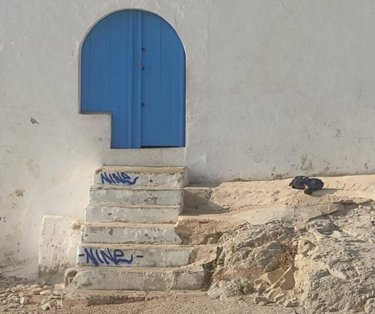 Graffiti on the stairs of a little house in Cala de la Barraca