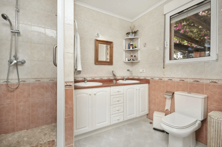 Baño en-suite con dos lavabos y ducha