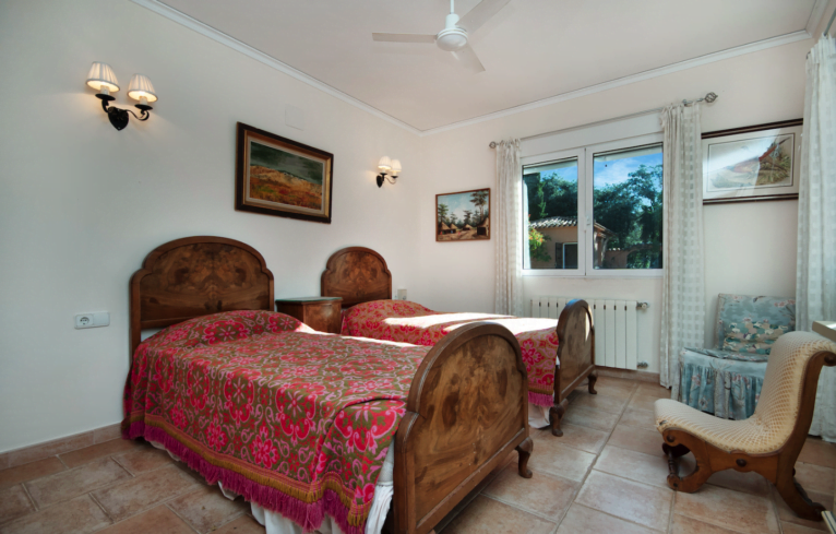 Dormitorio de estilo rústico-clásico con dos camas individuales