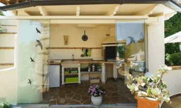 Zona de cocina exterior acristalada
