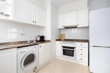 Cocina de la vivienda equipada con armarios en blanco