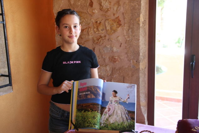 Imagen: Júlia Leyda muestra su foto en el libro de fiestas