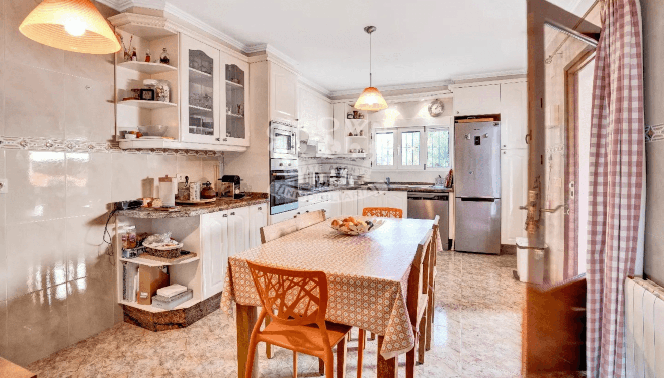 Cocina amplia que incluye una mesa en el centro