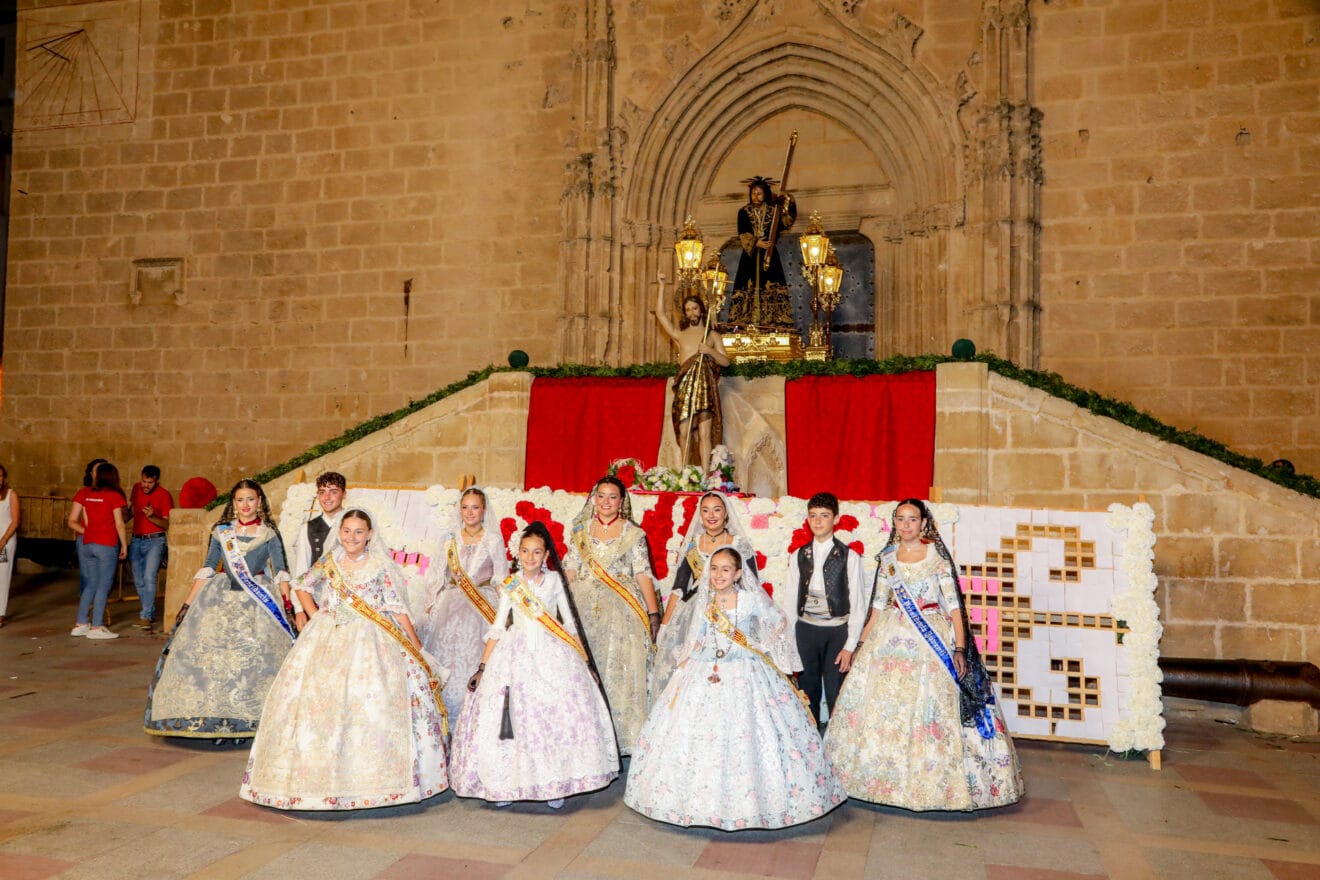 Cargos de Fogueres 2024 frente al tapiz de la Ofrenda de Flores Fogueres Sant Joan 2024