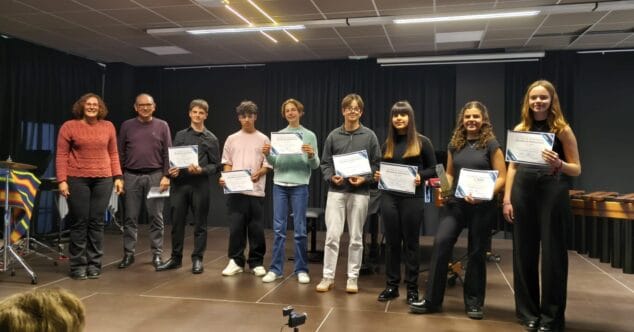 Imatge: Estudiants i professors del Conservatori de Xàbia posen amb diplomes a l'escenari després de la fase local del XV Concurs Intercentres.