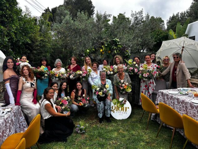 Imagen: Grupo de mujeres participantes en la fiesta de época Bridgerton en Xàbia, posando con ramos de flores en un jardín.