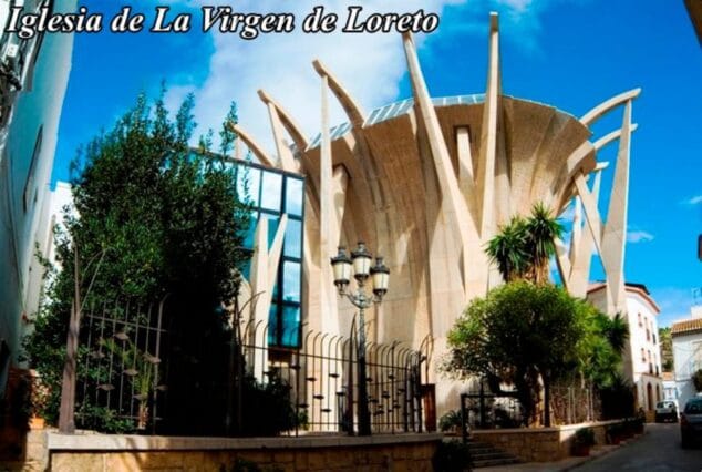 Imagen: Fotografía exterior de la moderna Iglesia de la Virgen de Loreto en Xàbia, con su característica estructura de hormigón que recuerda a un barco.